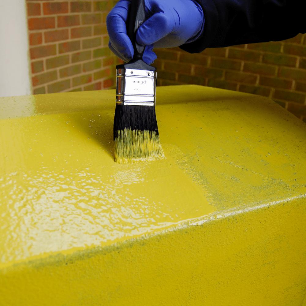 Multi-Purpose Paint Yellow being applied to metal surface by brush